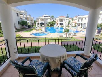 private-terrace-overlooking-pool-and-grounds