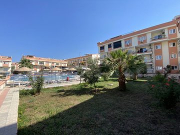 A Must-See Fully Furnished Apartment In Didim For sale - Large shady lawn areas