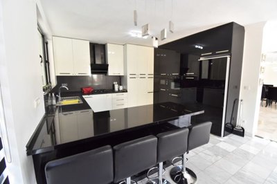 An Immaculate Detached Villa  For Sale with Pool In Fethiye - A fully fitted modern kitchen with breakfast bar and seating