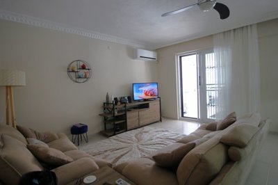 An Unmissable Two-Bed Apartment In Didim For sale - Lounge with balcony overlooking the pool