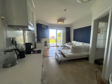 Divine Sea View Bodrum Garden Apartment In Gumusluk For Sale – Open-plan living space and kitchen