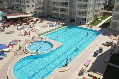 Newly-Built Duplex Apartment Is For Sale In Didim – Arial over the complex with communal pool 