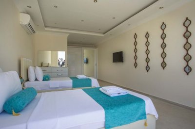 A Glamorous 4-Bedroom Fethiye Property For Sale - Twin bedroom with storage and modern furnishings