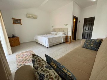 Pretty Fully Established Hotel In Dalyan For Sale - Double bedroom with seating area