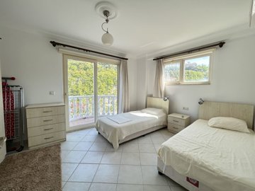 A Pretty Bodrum Apartment For Sale In Mugla, Milas - A large twin bedroom with balcony