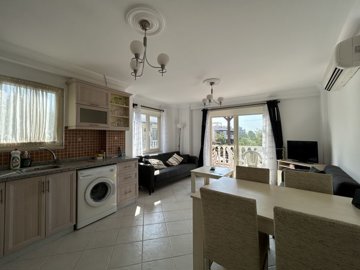 A Pretty Bodrum Apartment For Sale In Mugla, Milas - Living space with large balcony