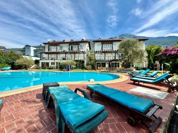 Ready-To-Move Apartment For Sale In Ovacik, Fethiye – Sun terraces surrounding the communal pool