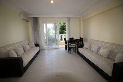 Delightful Furnished Apartment For Sale In Altinkum – Open-plan living room with balcony