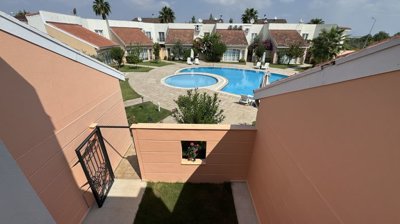 An Immaculate Apartment In Belek, Antalya For Sale - Rear view of the small yard and communal pool