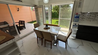 An Immaculate Apartment In Belek, Antalya For Sale - Living area thats leads out to a covered terrace and garden