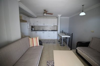 Fully Furnished Duplex Apartment For Sale In Didim – Lounge area through to the kitchen