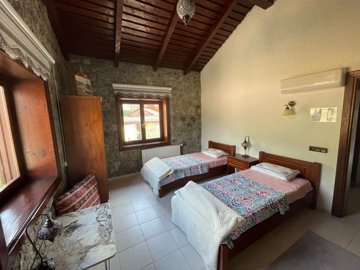 Ready-To-Move Uzumlu Stone Bungalow For Sale - Large twin bedroom with en suite bathroom