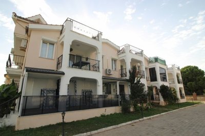 A Fully Furnished Didim Property In Sought After Complex – View to apartment block from the street