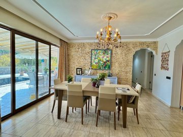 A Exquisite Bespoke Uzumlu Bungalow For Sale - Dining area with garden and pool views