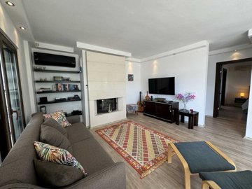 A Serene 2-Bedroom Apartment In Bodrum For Sale - A  large living room with modern fireplace