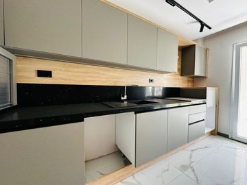 A Trendy Ground-Floor Apartment For Sale In Kusadasi - Modern cabinets and sleek work surfaces