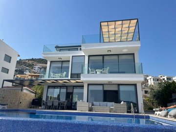 Deluxe Kalkan Property Is For Sale - Main view of the immaculate triplex villa with infinity pool