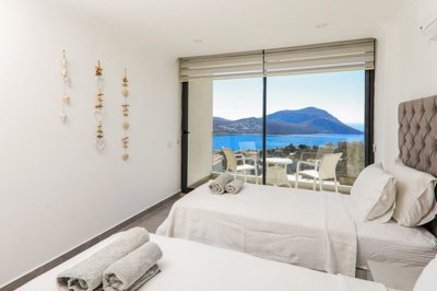 Deluxe Kalkan Property Is For Sale - A spacious twin bedroom with full sea views and a balcony