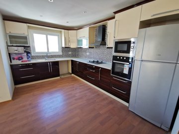 A Sea View Kusadasi Duplex Apartment For Sale With On-Site Facilities - A modern, fully fitted kitchen