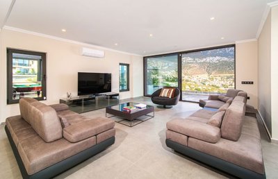 Magnificent Sea View Property For Sale In Kalkan - A modern, lounge with terrace access