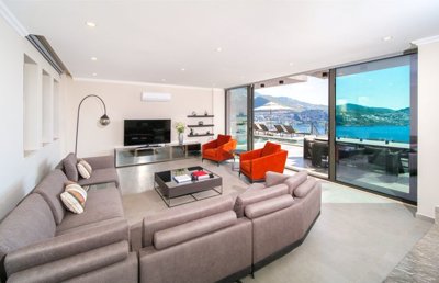 A High-End Sea-View Villa In Kalkan For Sale - A beautifully furnished lounge with terrace access