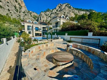 A Lovingly-Maintained Smart Home Villa For Sale In Fethiye - Main view of the villa, pool and feature seating area with fire pit