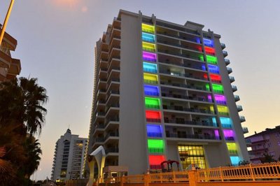 Striking Alanya Property For Sale In Mahmutlar - Main apartment building with colorful lighting