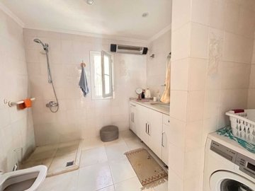 Traditional Bodrum Villa For Sale – A large main bathroom with vanity and storage