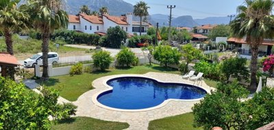 Detached Villa With A Shared Pool For Sale In Dalyan - Pretty mature gardens and the communal, uniquely shaped pool