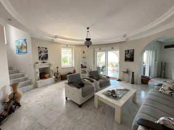 Magnificent Property For Sale In Kargicak, Alanya - Living area with a fireplace and fully fitted kitchen