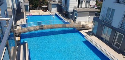 A Modern Triplex Villa For Sale in Belek, Antalya - A large shared swimming pool with sun terraces