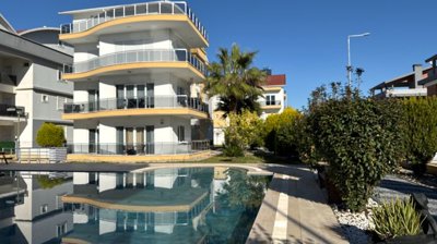 A Pristine Antalya Apartment For Sale - Main view of the apartment building and communal pool