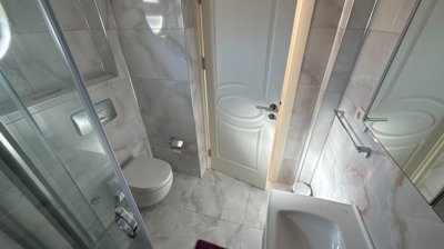 A Pristine Antalya Apartment For Sale - The ensuite shower room with a corner shower and sanitaryware units