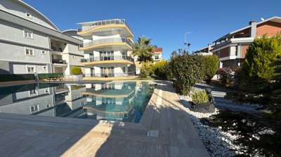 A Pristine Antalya Apartment For Sale - A large social exterior with a pool and sun terraces