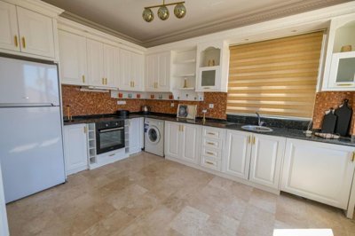 Versatile Sea View Property For Sale In Alanya - A huge kitchen fully decked out with appliances