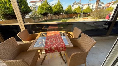 A Ready To Move Apartment In Antalya For Sale - Seating and dining space on the long balcony