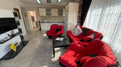 A Ready To Move Apartment In Antalya For Sale - A fully furnished living space and kitchen