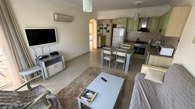 Spotless Apartment In Antalya For Sale - Lounge to the kitchen with built-in white goods and appliances