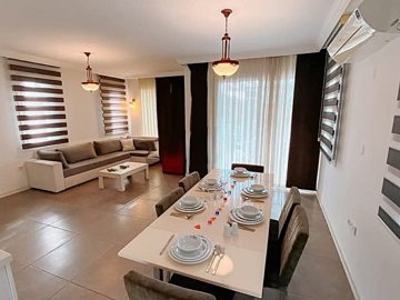 Exquisite Fethiye Property For Sale - A spacious living area with dining area through to the lounge