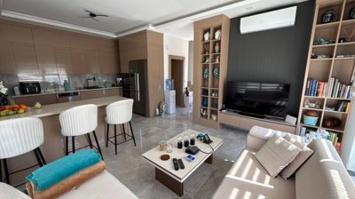 A Desirable Twin Villa For Sale in Antalya - Open-plan living room with a lounge, dining space and kitchen