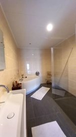 fully insulated, luxury bathroom with walk-in shower, bathtub, hanging toilet