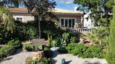 pretty villa nestled amongst a beautiful mature garden